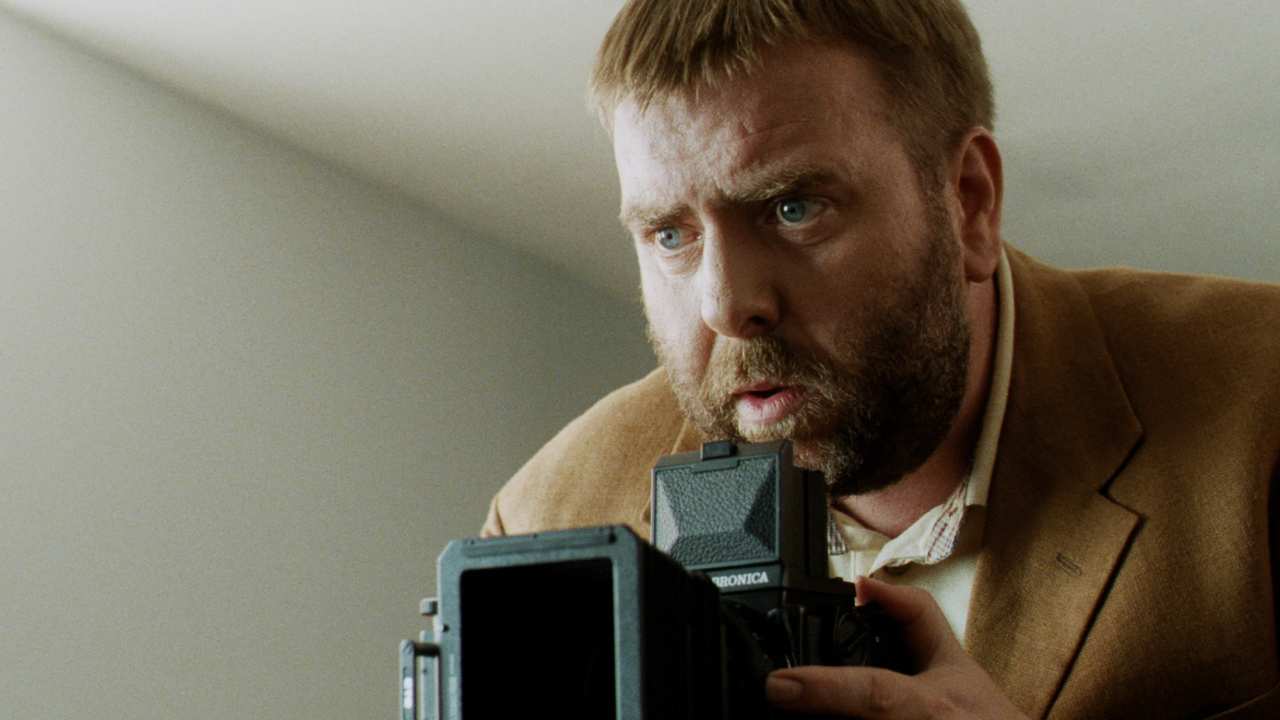 closeup of a bearded man with a camera